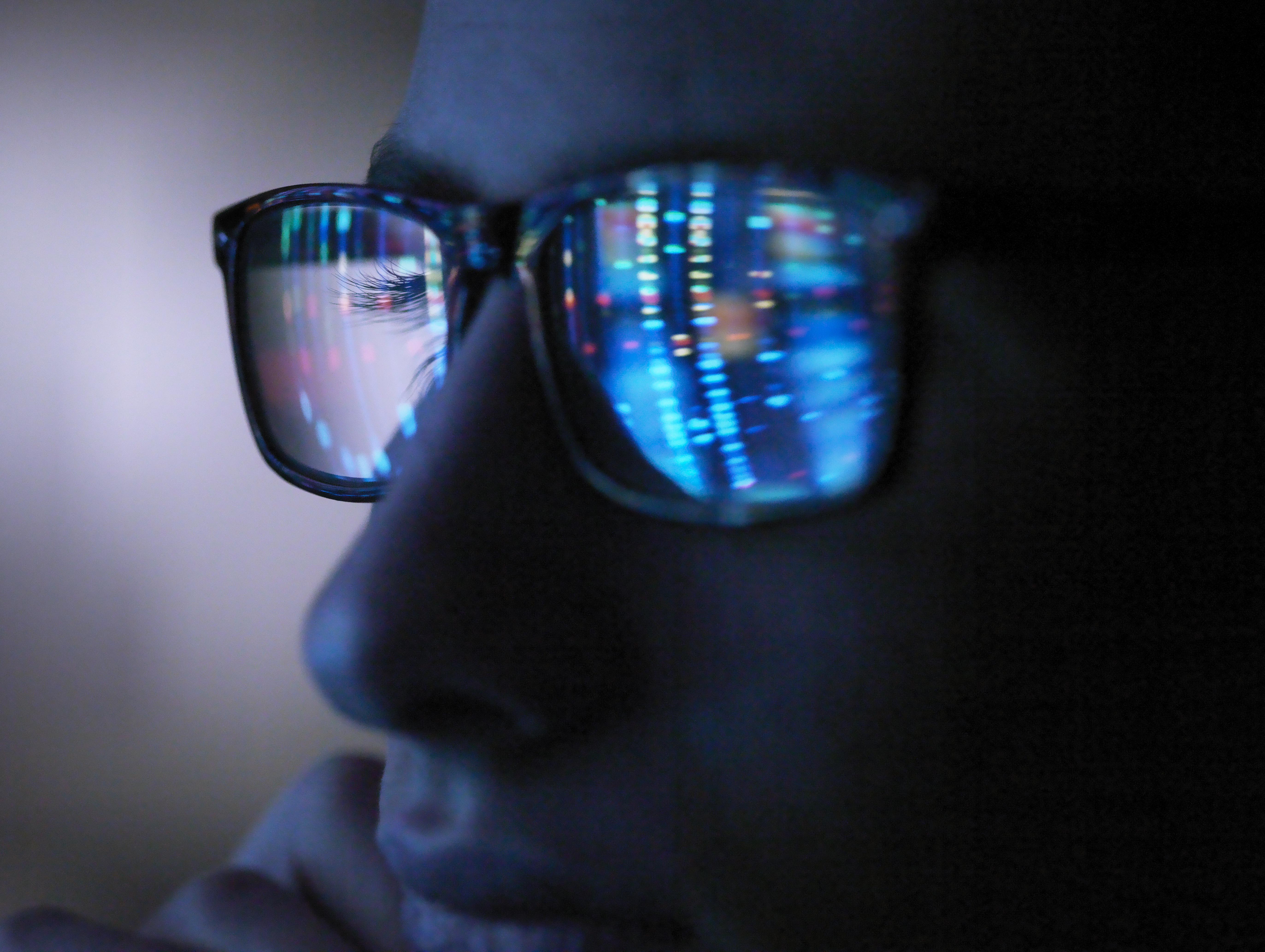 A computer screen reflected in someone's glasses